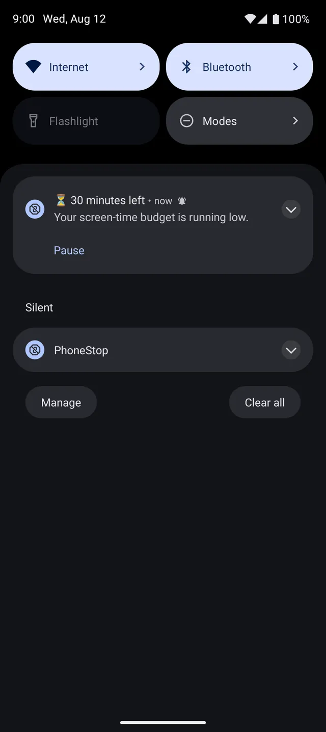 A PhoneStop budget warning arriving on top of another app.